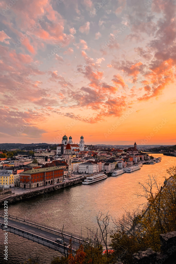 Passau, UNESCO. Exclusive historical town with Castle and Church at sunset. Beautiful spring evening landscape with an illuminated monument and Danube river. Shiny premium cityscape scene from Germany