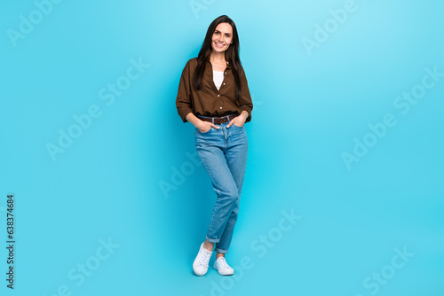 Full body photo of young business woman hands pockets denim jeans posing model vogue levis brand clothes isolated on blue color background