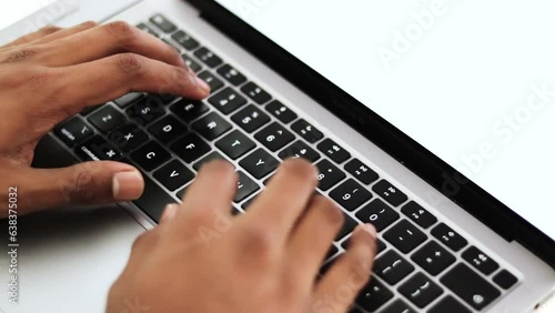 Close up view of a young businessman's busy hands working on a laptop or computer keyboard, sending emails, and surfing on a web browser