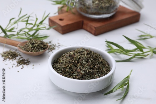 Dry and fresh tarragon on white table