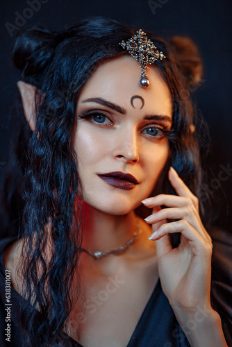 Beautiful black haired demon girl in seylor moon style. Dark elf girl in black dress on black background. 