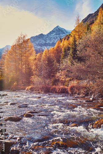 autumn landscape in the mountains, river in the foreground, mountains in the background