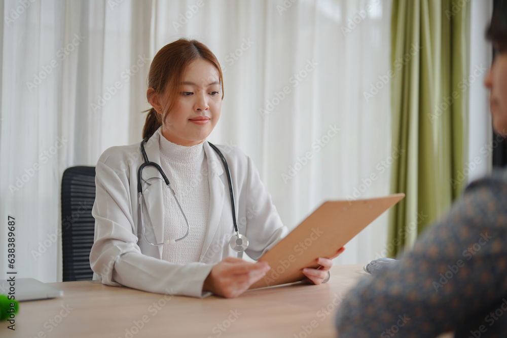 Asian woman doctor gives consultation to woman patient to suggest treatment and guideline and healthcare concept in medical office.