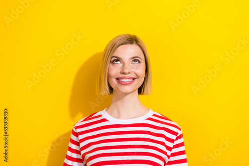 Photo of positive glad girl toothy smile wear fashionable clothes look up promo poster empty space isolated on yellow color background