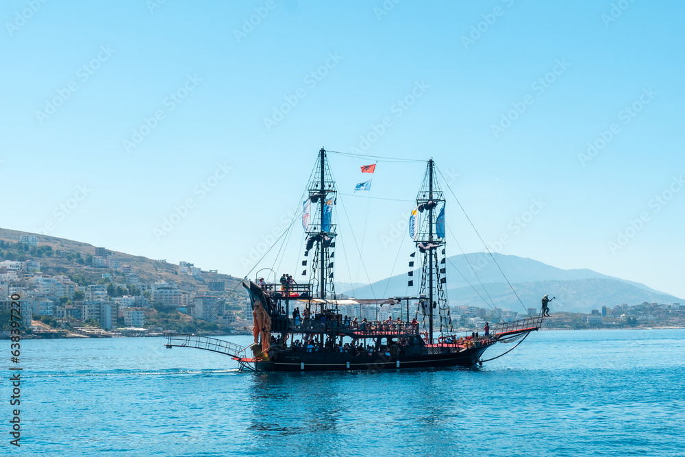 Tourist boats on the beaches of the city of Sarande or Saranda on the Albanian riviera seen from a boat, Albania Tourist boats on the beaches of the city of Sarande or Saranda on the Albanian riviera seen from a boat, Albania