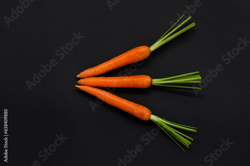 Three carrots on a black background