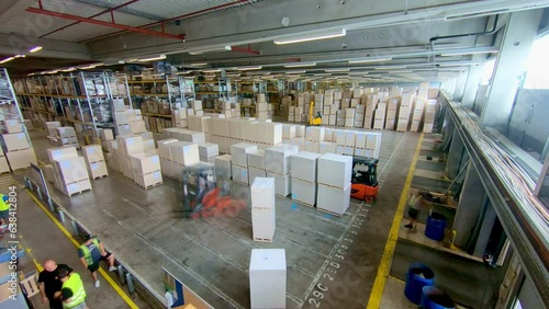 Freight shipping center warehouse employees operating forklift and sorting container timelapse top view. Storehouse workers driving lift truck and transporting boxes time lapse high angle view