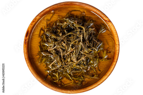 Black thyme with olive oil at wooden bowl. Zahter isolated on white background. Mediterranean food. vegan food. Top view photo