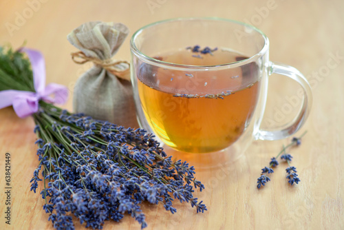 Fresh delicious tea with lavender and lavender flowers on a wooden table