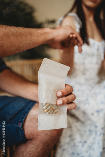 man holding woman's hand holding mushroom pills