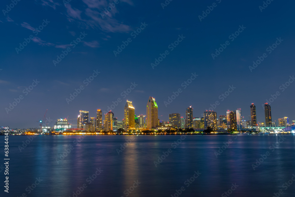 San Diego skyline at night with water colorful reflections, view from Coronado island, California