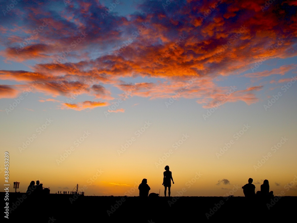 Silhouette of a funny woman during the sunset at the beach of Saint-Gilles les Bains, La Réunion, France 