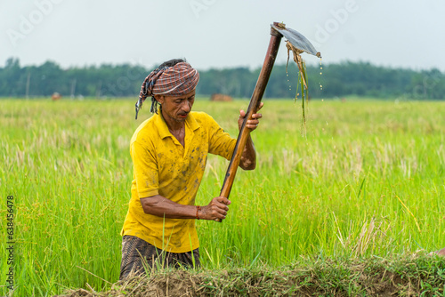 Photography by using a garden hoe a farmer working on a agricultural farm