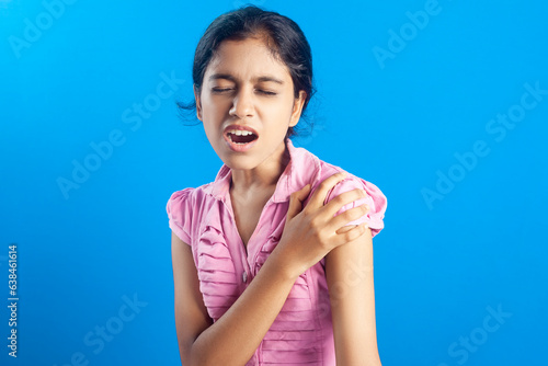 Indian girl struggling with shoulder pain photo