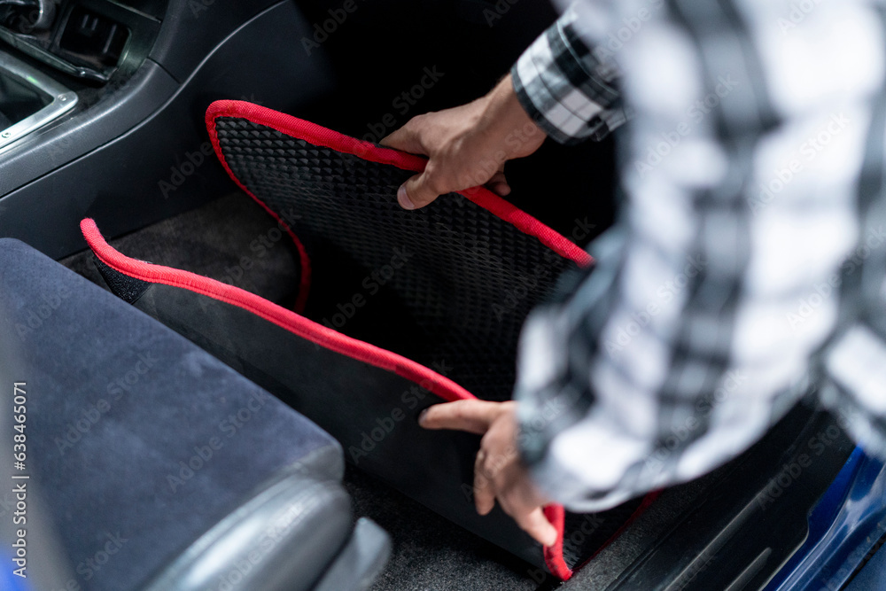 a person takes a dirty car mat to wash a person takes a dirty car mat to wash