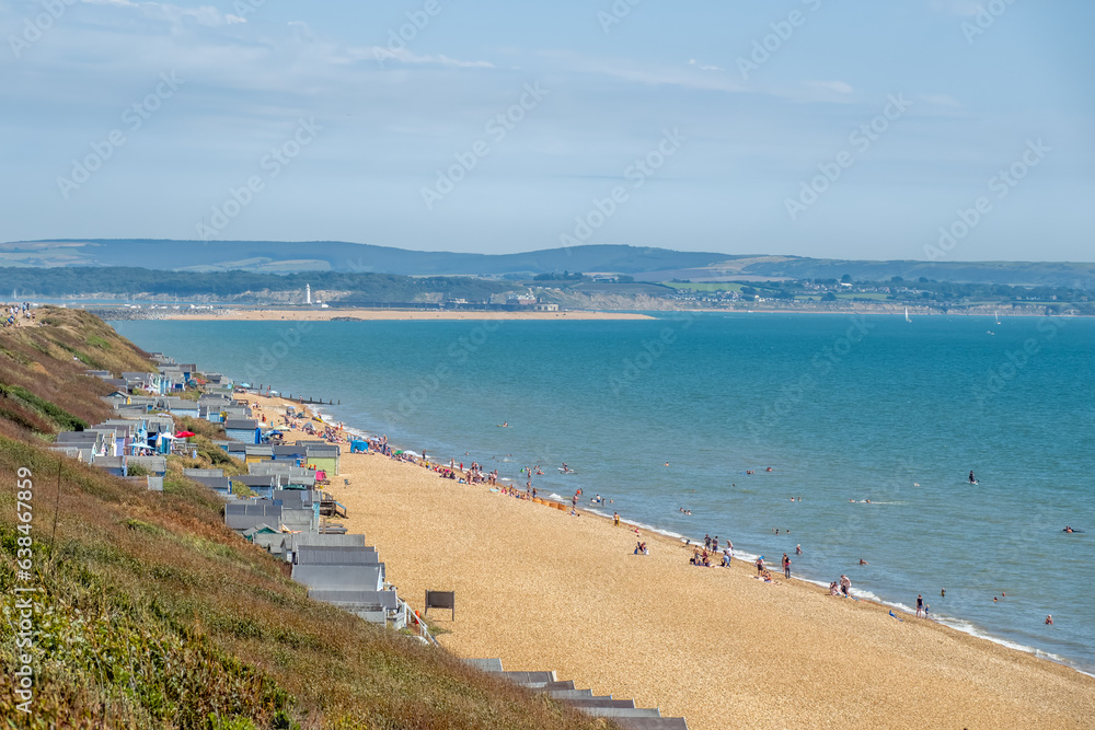 view of beach huts at Milford On Sea Hampshire England with the sea and The Isle of Wight in the background