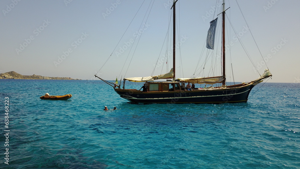 Yacht, sailing in Greece and summer on ocean holiday, relax in freedom and nature on blue water. Boat vacation, travel in sun and tropical cruise on sea adventure to island coast in beach transport.