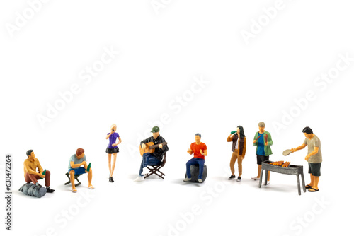 Miniature people are making barbeque, drinking beverages, making memories, and laughing isolated on white background