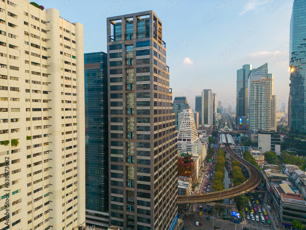Aerial view city office building with BTS urban train transport sunset sky Silom district