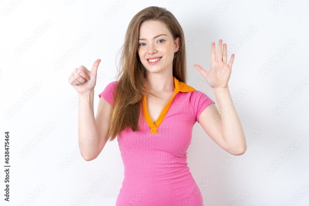 Fototapeta premium young beautiful red haired woman showing and pointing up with fingers number six while smiling confident and happy.