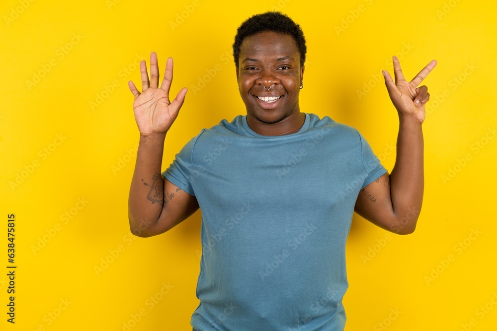 MODEL showing and pointing up with fingers number eight while smiling confident and happy. MODEL showing and pointing up with fingers number eight while smiling confident and happy.