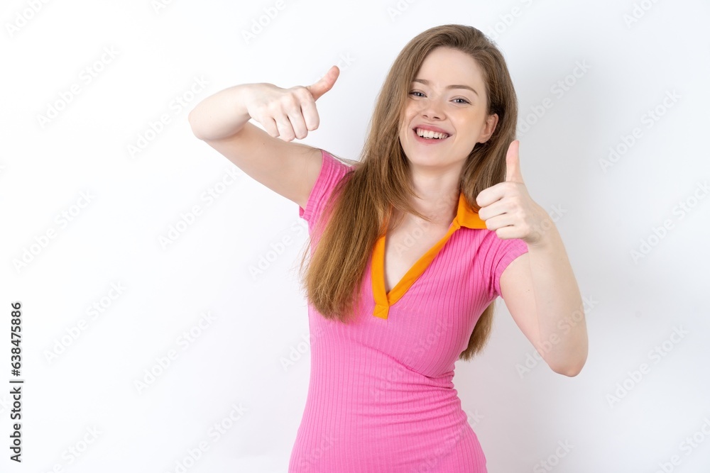 young beautiful red haired woman approving doing positive gesture with hand, thumbs up smiling and happy for success. Winner gesture. young beautiful red haired woman approving doing positive gesture with hand, thumbs up smiling and happy for success. Winner gesture.