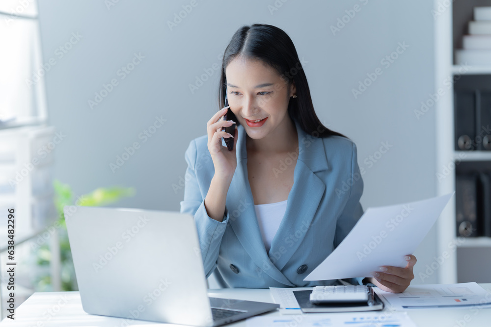 Shot of a beautiful young financial assistant sitting in front of laptop and fill the form in the office.