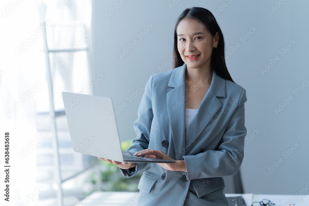 Shot of a beautiful young financial assistant sitting in front of laptop and fill the form in the office. Shot of a beautiful young financial assistant sitting in front of laptop and fill the form in the office.