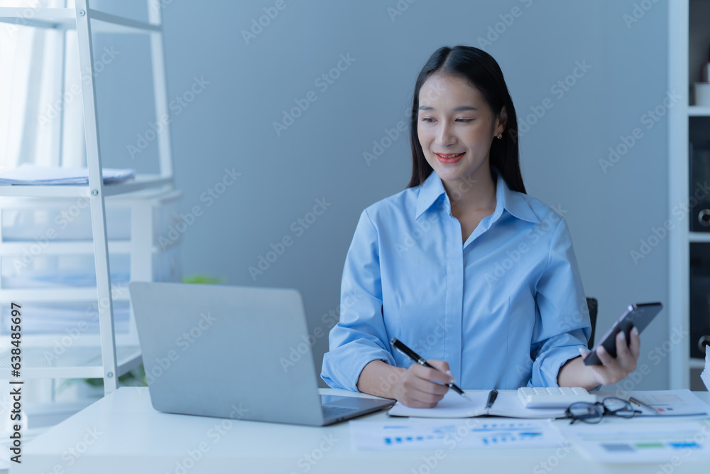 Shot of a beautiful young financial assistant sitting in front of laptop and fill the form in the office. Shot of a beautiful young financial assistant sitting in front of laptop and fill the form in the office.