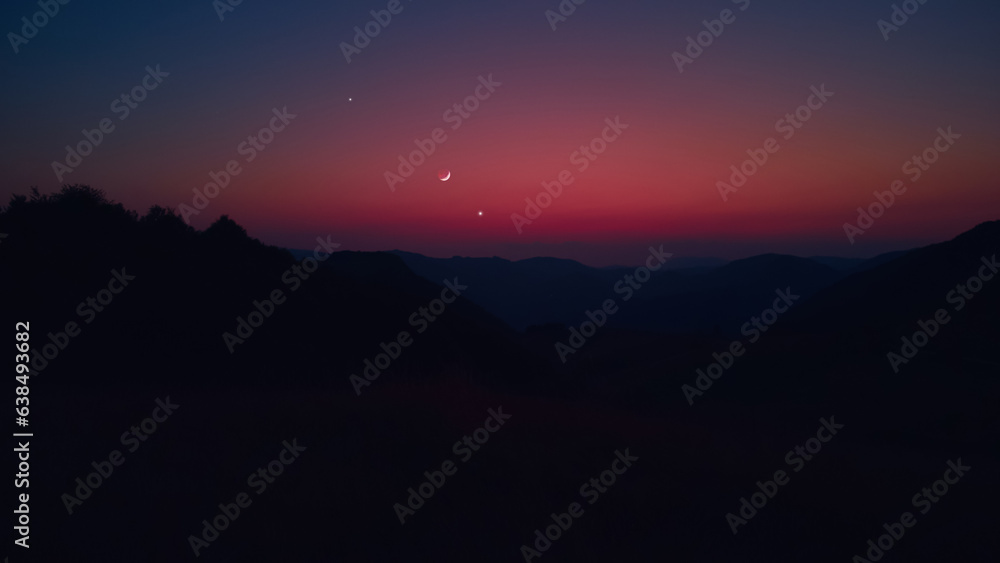 Silhouette of a countryside with Milky Way stars, planets and crescent Moon.