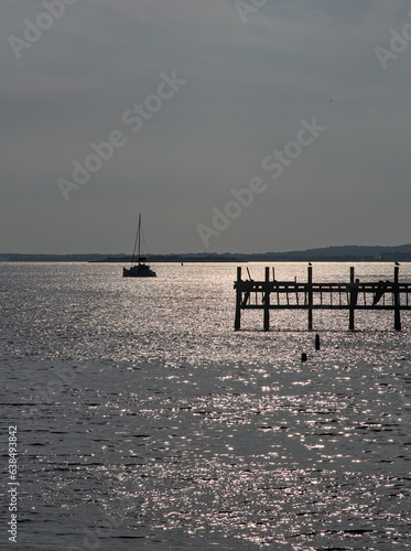 boat and pier in late day sun (sunset light) seascape, hudson river, ocean