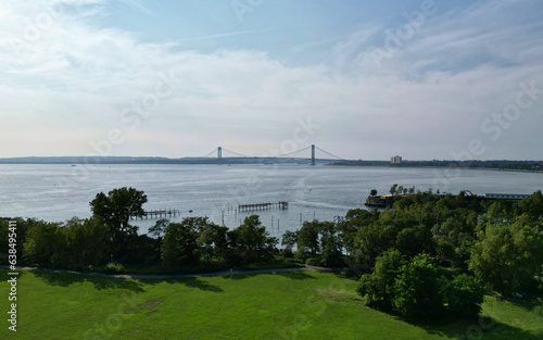 Wallpaper Mural aerial view of Verrazzano Narrows Bridge at sunset (suspension bridge between brooklyn, staten island in bay ridge) still water hudson river in new york city harbor drone shot from above looking down Torontodigital.ca