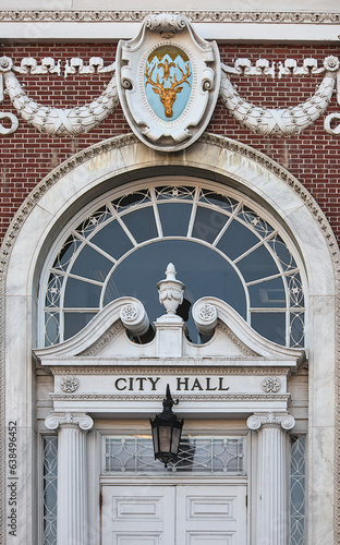 city hall building entrance detail (in burlington vermont) deer head, door, light, lantern, window sign