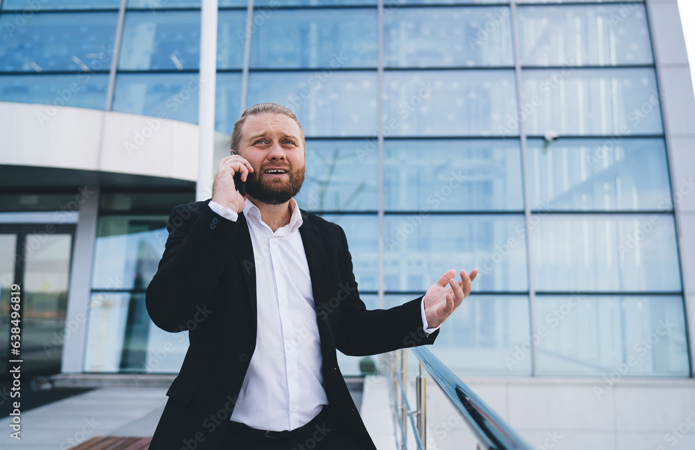Serious businessman calling on smartphone Serious businessman calling on smartphone