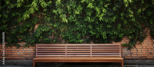 Fototapeta Naklejka Na Ścianę i Meble -  Brick wall background with a bushy bench for resting