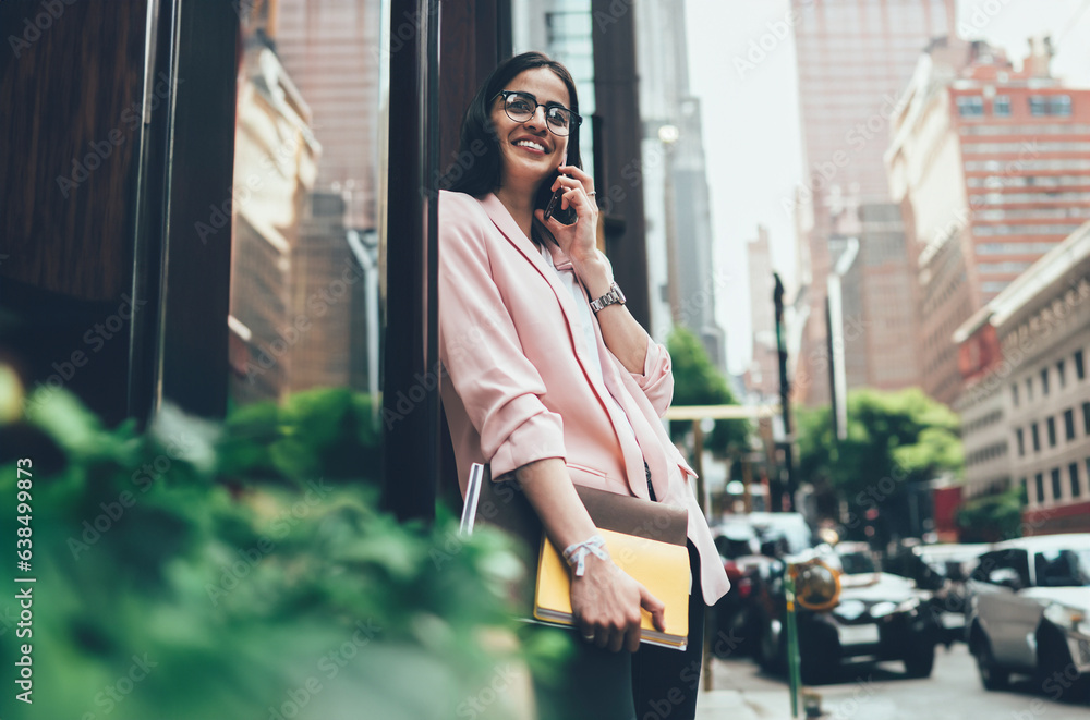Fototapeta premium Happy businesswoman talking on phone in city