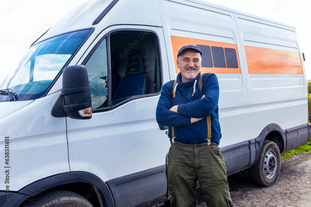 Happy confident male driver standing in front on his van and looking at camera. Happy confident male driver standing in front on his van and looking at camera.
