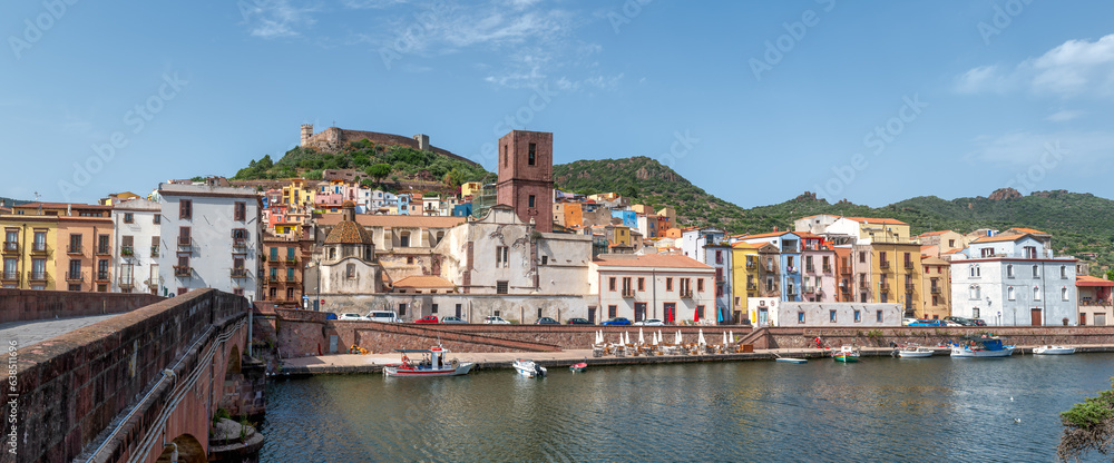 Echoes of History: Bosa's Panoramic Splendor. From the banks of the Temo River, near the venerable Ponte Vecchio, the picturesque town of Bosa unfolds in Sardinia, an Italian gem. 