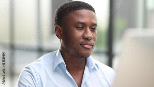 Thoughtful black man in eyeglasses stack with hard task  looking at computer screen  thinking of problem solution