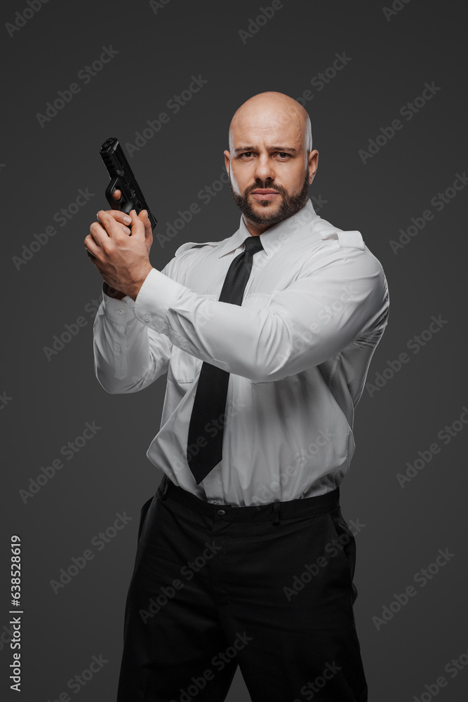 Strong bearded individual in crisp white attire readies his firearm, suggesting roles of security or detective Strong bearded individual in crisp white attire readies his firearm, suggesting roles of security or detective