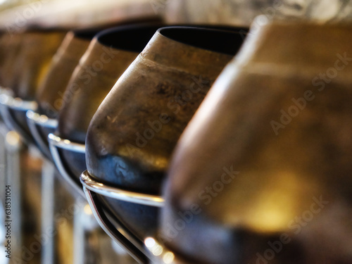 Schilderij op canvas Within the Temple of the Reclining Buddha in Bangkok, a row of sizable pots with selective focus