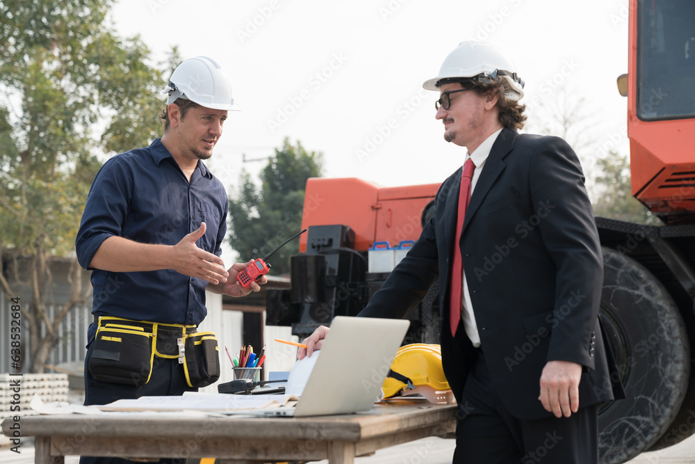 Two foreman builder discussing and planning of precast concrete wall structure quality at construction site. Group of construction supervisor working at construction site Two foreman builder discussing and planning of precast concrete wall structure quality at construction site. Group of construction supervisor working at construction site