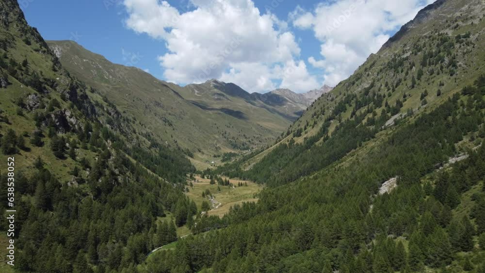 Aerial view of forest and mountains in Val Grande (Alta Valle Camonica), Lombardy, Italy. Trees and mountain range seen from drone in the sky. Alpine valley and nature of Italian Alps Aerial view of forest and mountains in Val Grande (Alta Valle Camonica), Lombardy, Italy. Trees and mountain range seen from drone in the sky. Alpine valley and nature of Italian Alps