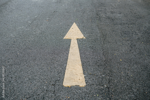 Arrow on the road and yellow