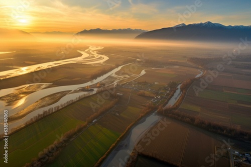 An aerial view of sunrise over Fraser River and farms near Chilliwack city in British Columbia, Canada. Generative AI