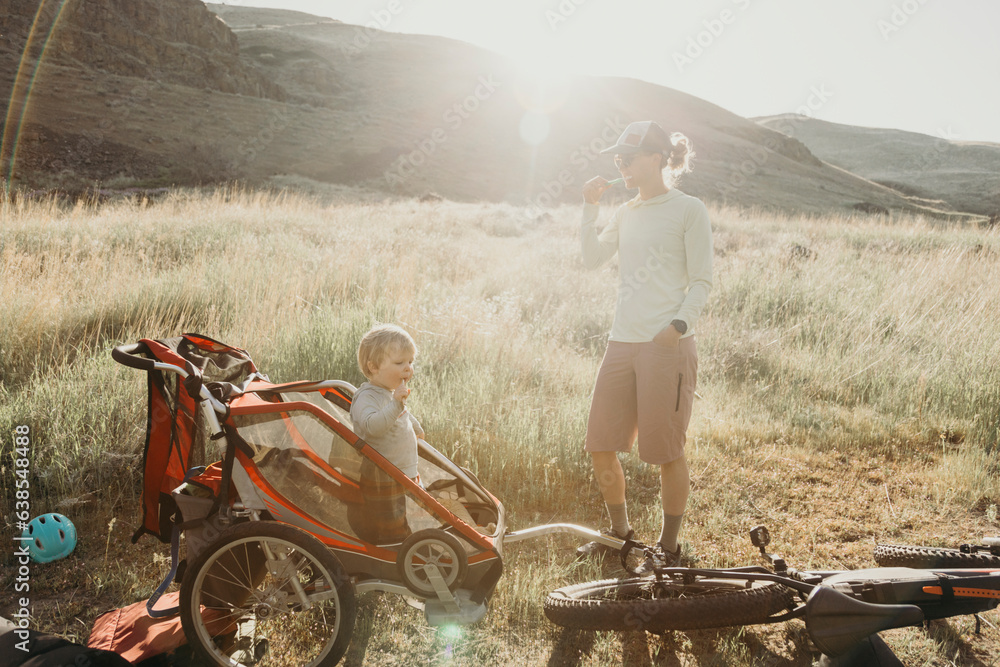 Obraz premium A young toddler brushes his teeth next to his mother during a camping trip in Oregon.