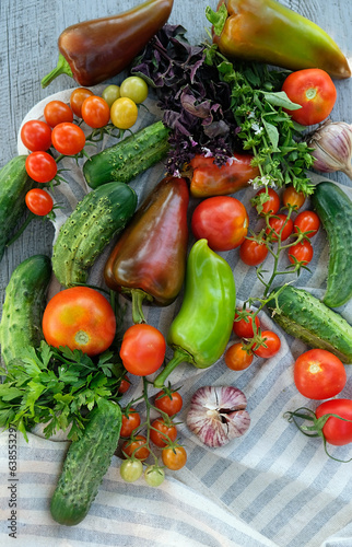 Fototapeta Naklejka Na Ścianę i Meble -  fresh ripe vegetables and towel on wooden table close up. organic Food background. concept of harvesting, assorted of raw vegetables for healthy vitamin food, diet. template for design. flat lay