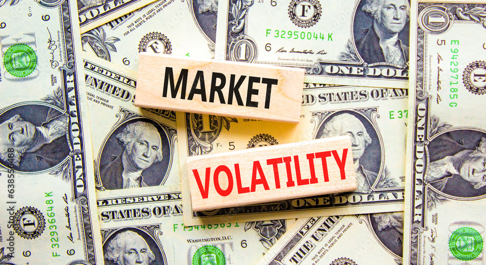 Market volatility symbol. Concept words Market volatility on beautiful wooden blocks. Dollar bills. Beautiful background from dollar bills. Business market volatility concept. Copy space.orange