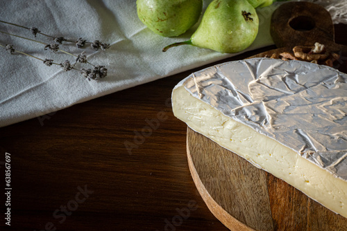 Fototapeta Naklejka Na Ścianę i Meble -  Camembert and brie cheese on wooden background with nuts, honey and fruits. Dairy products.