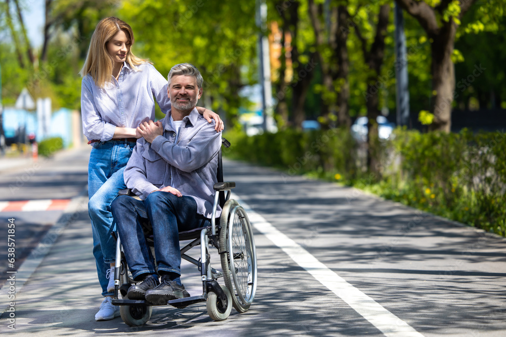 Husband in wheelchair and loving wife walking in city street. Husband in wheelchair and loving wife walking in city street.